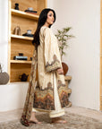 Woman in a traditional outfit standing in a room with wooden shelves and decor.